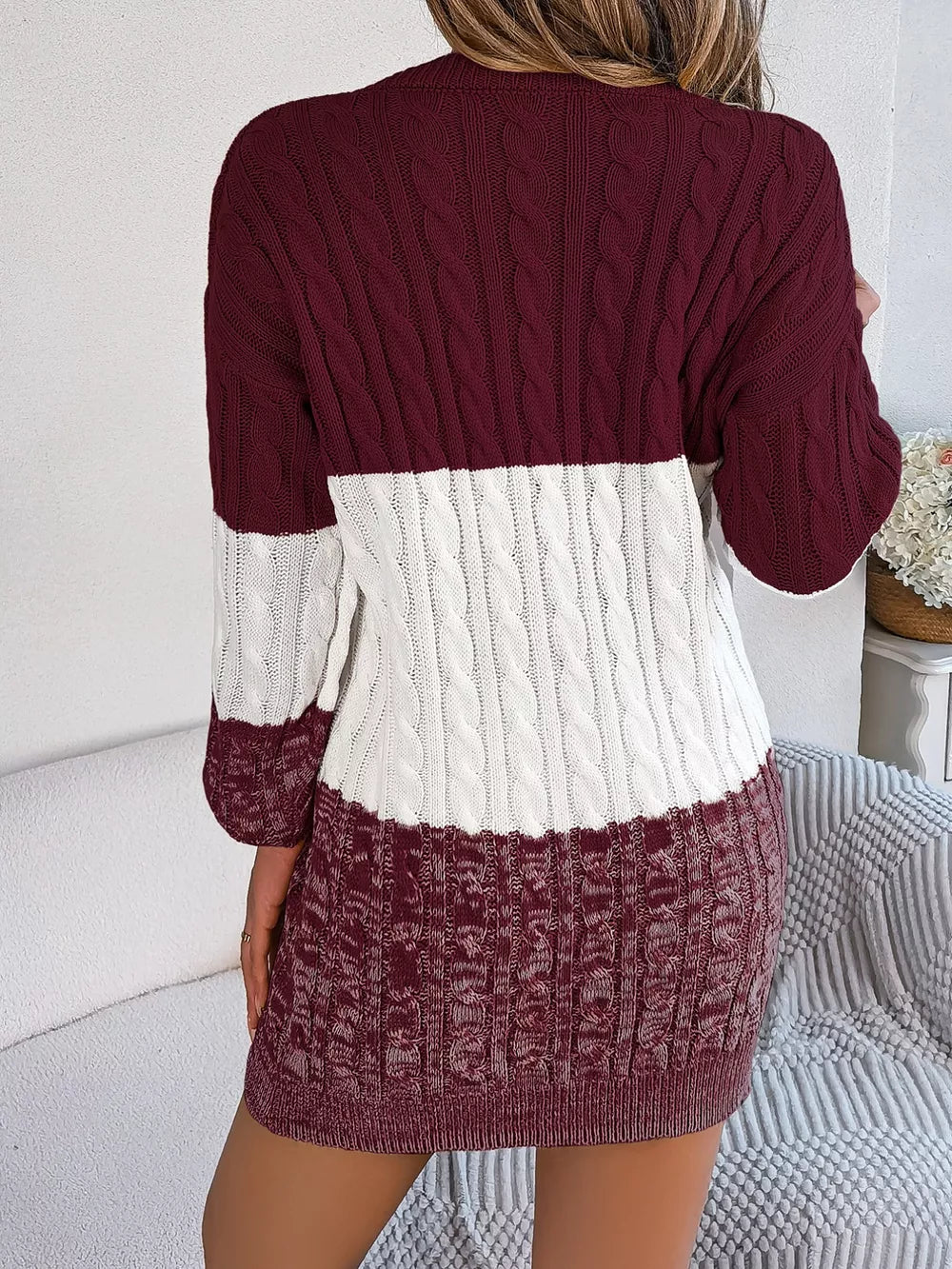Textured cable knit sweater dress in burgundy and white colorblock.