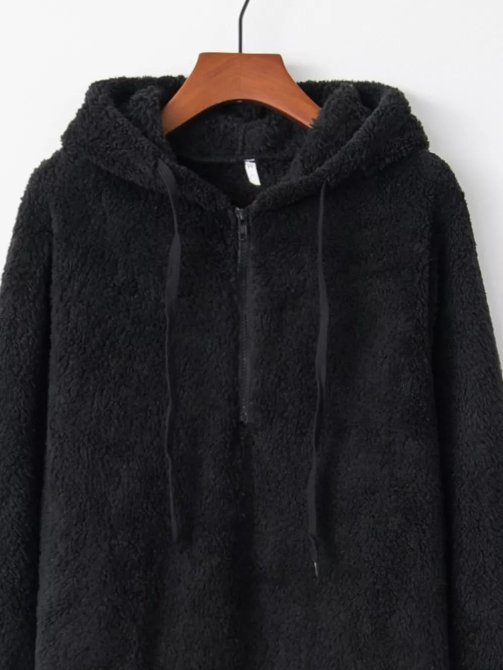 Black cozy half-zip fleece hoodie with drawstring and hood.