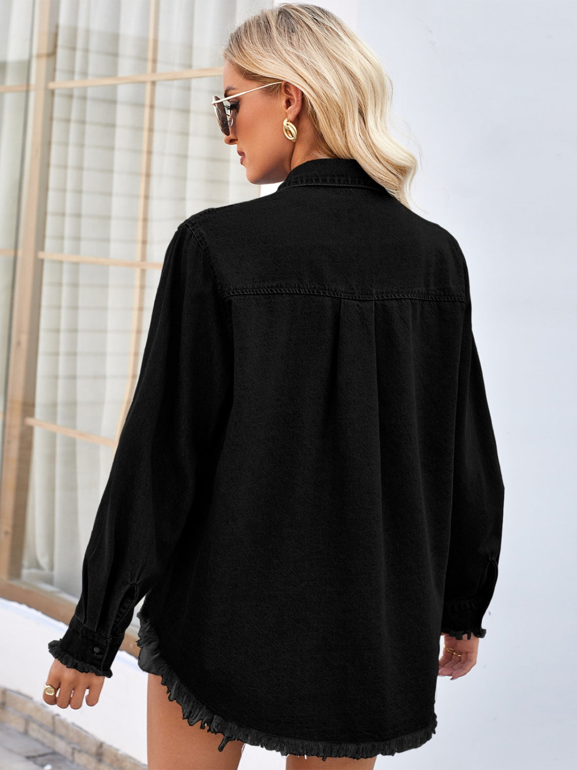 Black denim shirt with sequin embellishments, long sleeves, and frayed hem.