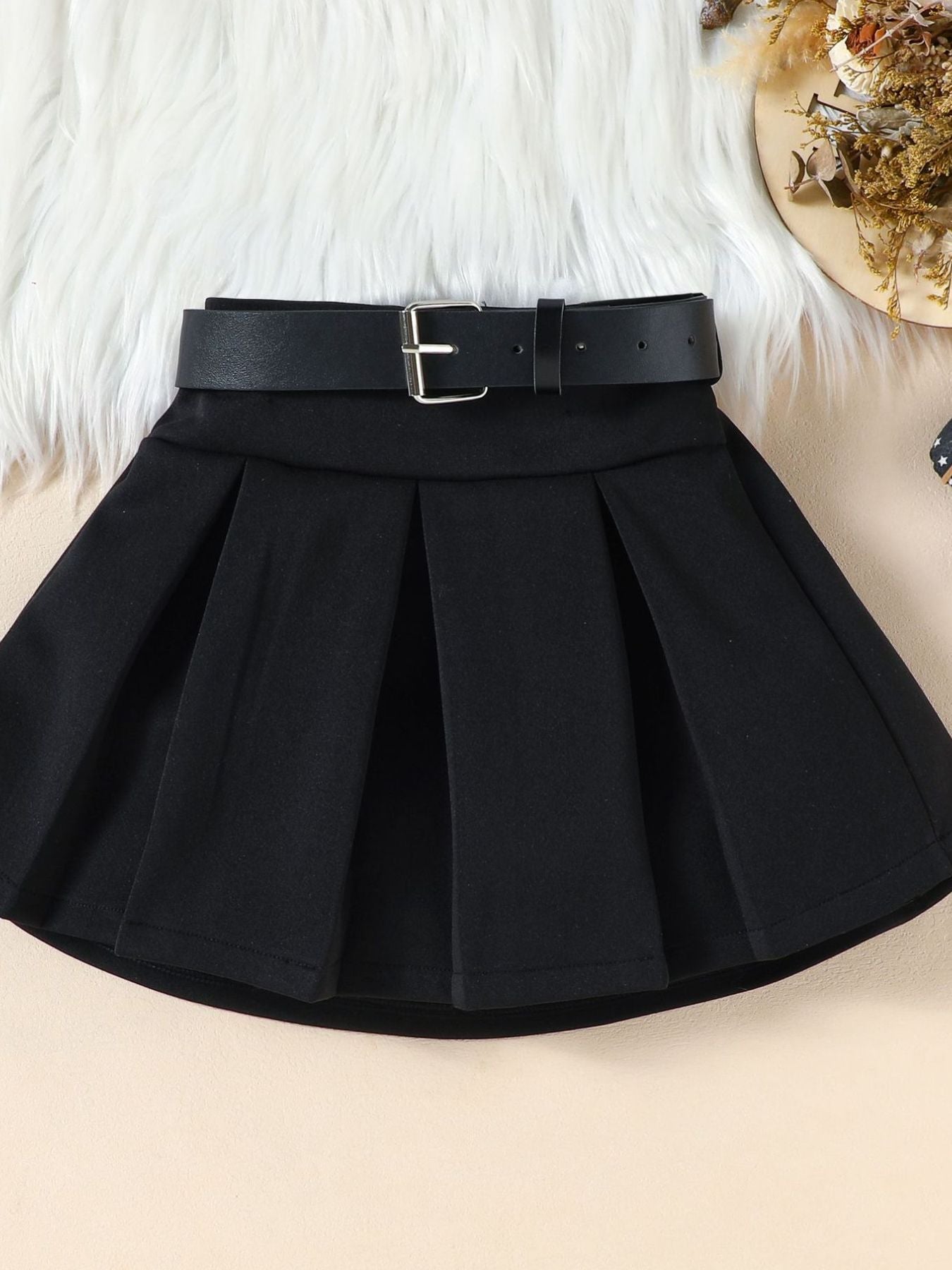 Black pleated skirt with a black belt and silver buckle