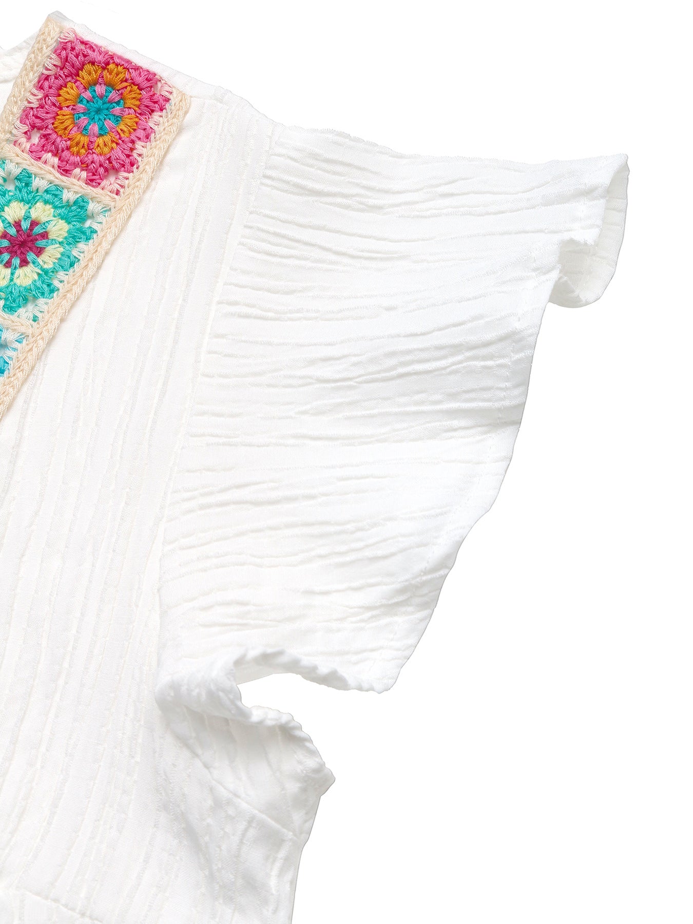 White crinkled maternity blouse with colorful crochet V-neck detail and flutter sleeves.