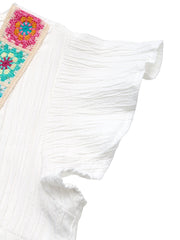 White crinkled maternity blouse with colorful crochet V-neck detail and flutter sleeves.