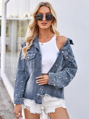 Denim jacket in dusty blue with pearl embellishments and frayed hem.