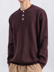 Men's ribbed knit henley top in dark curry with button details.