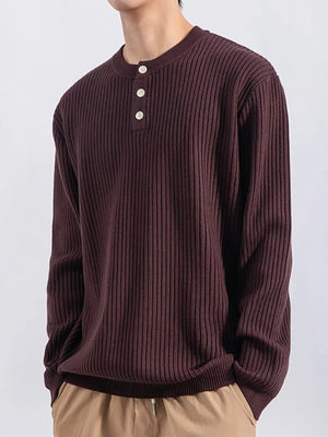 Men's ribbed knit henley top in dark curry with button details.