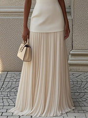 Elegant white pleated maxi dress with a boat neck and a smooth bodice.