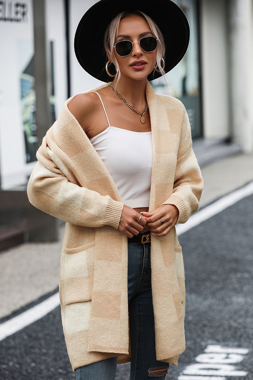 Oversized tan checkerboard knit duster coat with pockets and open front.