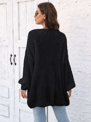 Black open knit cardigan with balloon sleeves and a relaxed fit.