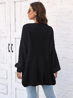 Black open knit cardigan with balloon sleeves and a relaxed fit.