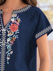 Navy blue blouse with floral embroidery and notched neckline