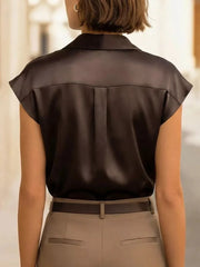 Black lustrous cap sleeve button-up shirt with back pleats.