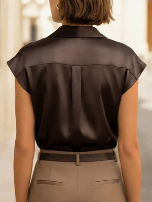 Black lustrous cap sleeve button-up shirt with back pleats.