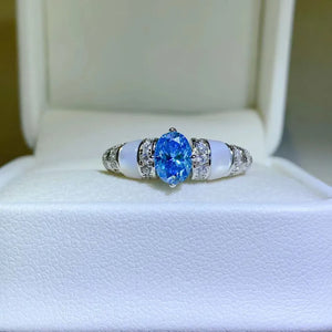 Silver ring with blue oval moissanite and mother-of-pearl accents