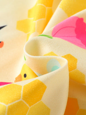 Yellow baby one-piece with playful duck and honeycomb print.