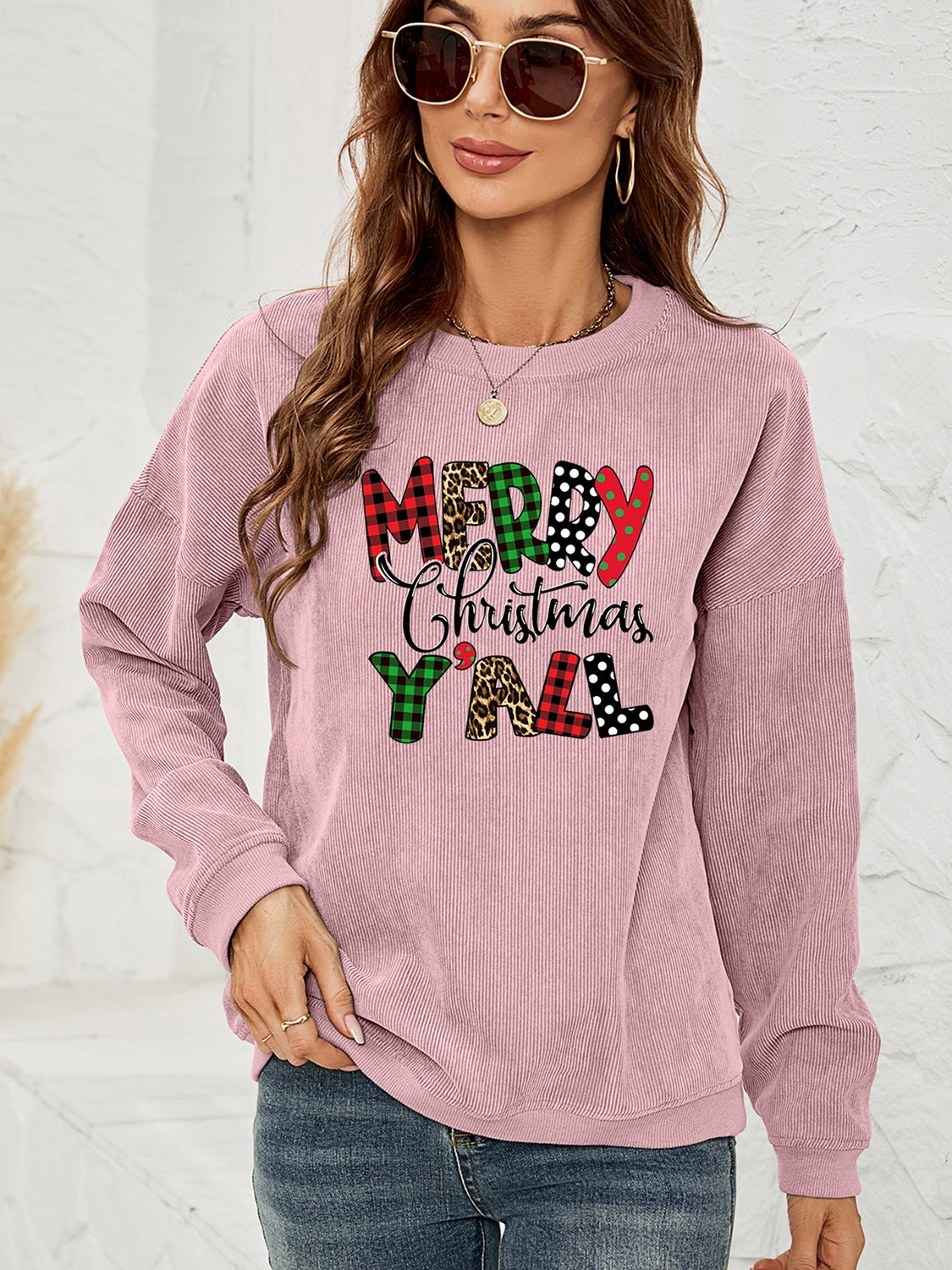 Dusty Pink corduroy sweatshirt with Merry Christmas Y'all graphic in buffalo plaid, leopard, and polka dot patterns.
