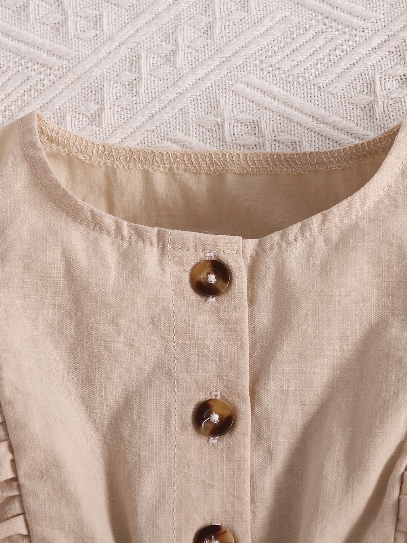 Apricot baby set with button front and ruffle trim detail.
