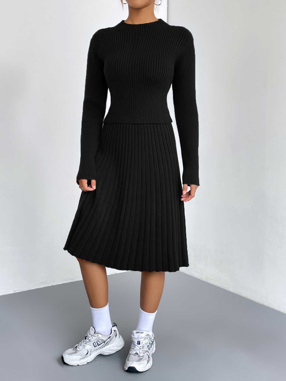 Black ribbed knit fit-and-flare co-ord set with long sleeves and a mock neck.