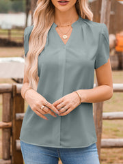 Gray notched neckline petal sleeve blouse with button detail and soft pleats.