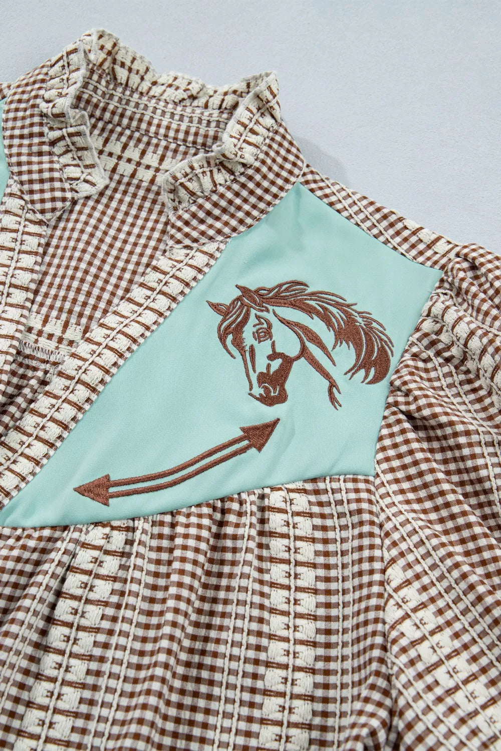 Brown gingham maternity shirt with embroidered horse yoke and puff sleeves.