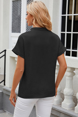 Black textured V-neck blouse with rolled short sleeves and a casual fit.