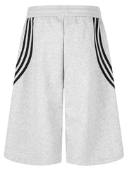 Gray cropped sweatpants with black side stripes and wide legs