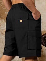 Black cargo shorts with drawstring waist and multiple pockets, featuring a gold accent on the top pocket flap.