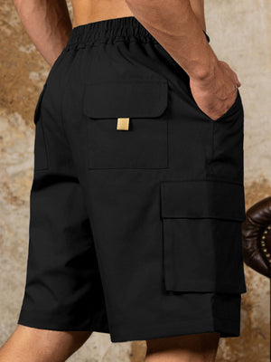 Black cargo shorts with drawstring waist and multiple pockets, featuring a gold accent on the top pocket flap.
