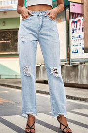 Light wash straight leg jeans with distressed details and frayed hem