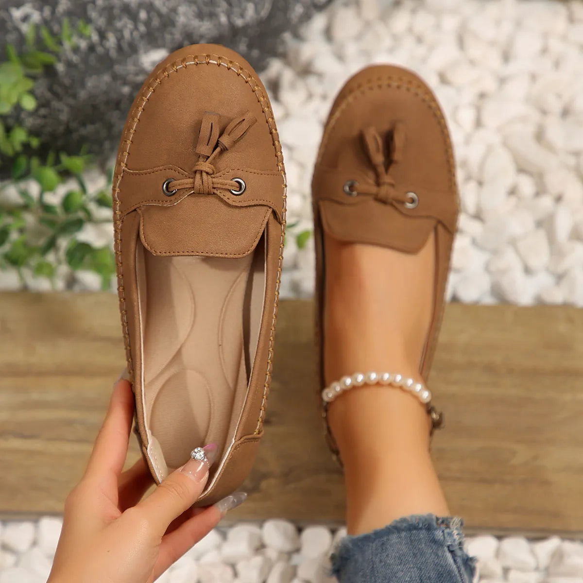 Tassel-trimmed suede loafer flats in Khaki, showing detail of bow and metal eyelets.