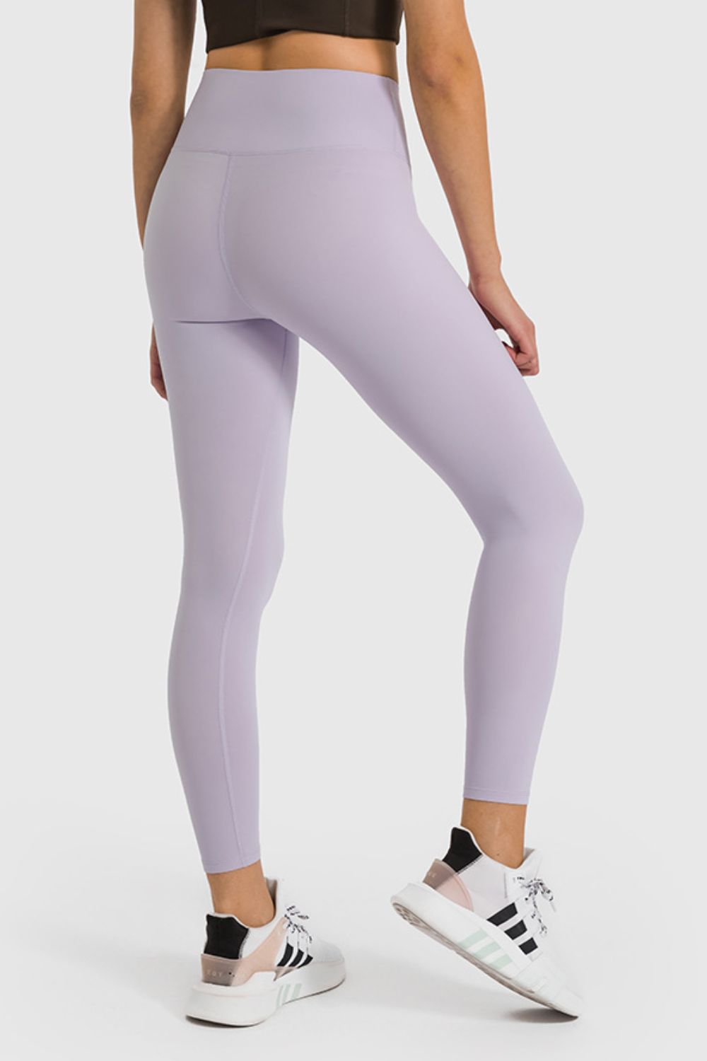 Lilac high-waist performance leggings with ankle length, shown from the back.