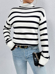 Oversized black and white striped turtleneck sweater with ribbed cuffs and hem.
