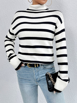Oversized black and white striped turtleneck sweater with ribbed cuffs and hem.