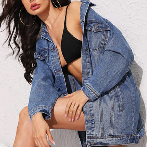 Oversized medium wash denim boyfriend jacket with button front and chest pockets.
