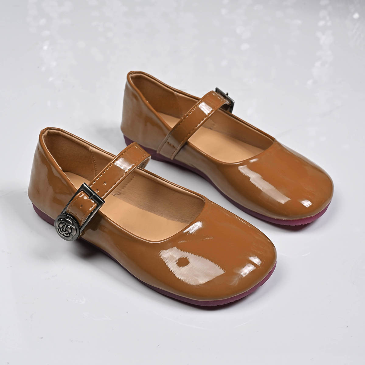Brown patent leather buckle strap Mary Jane loafers with rose detail.