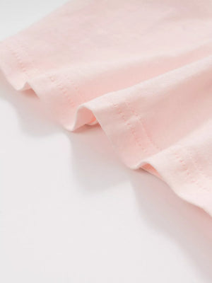 Pink cotton toddler t-shirt detail showing hem stitching.
