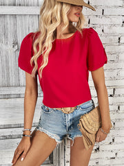 Red slit sleeve blouse with puff sleeves and a round neckline.