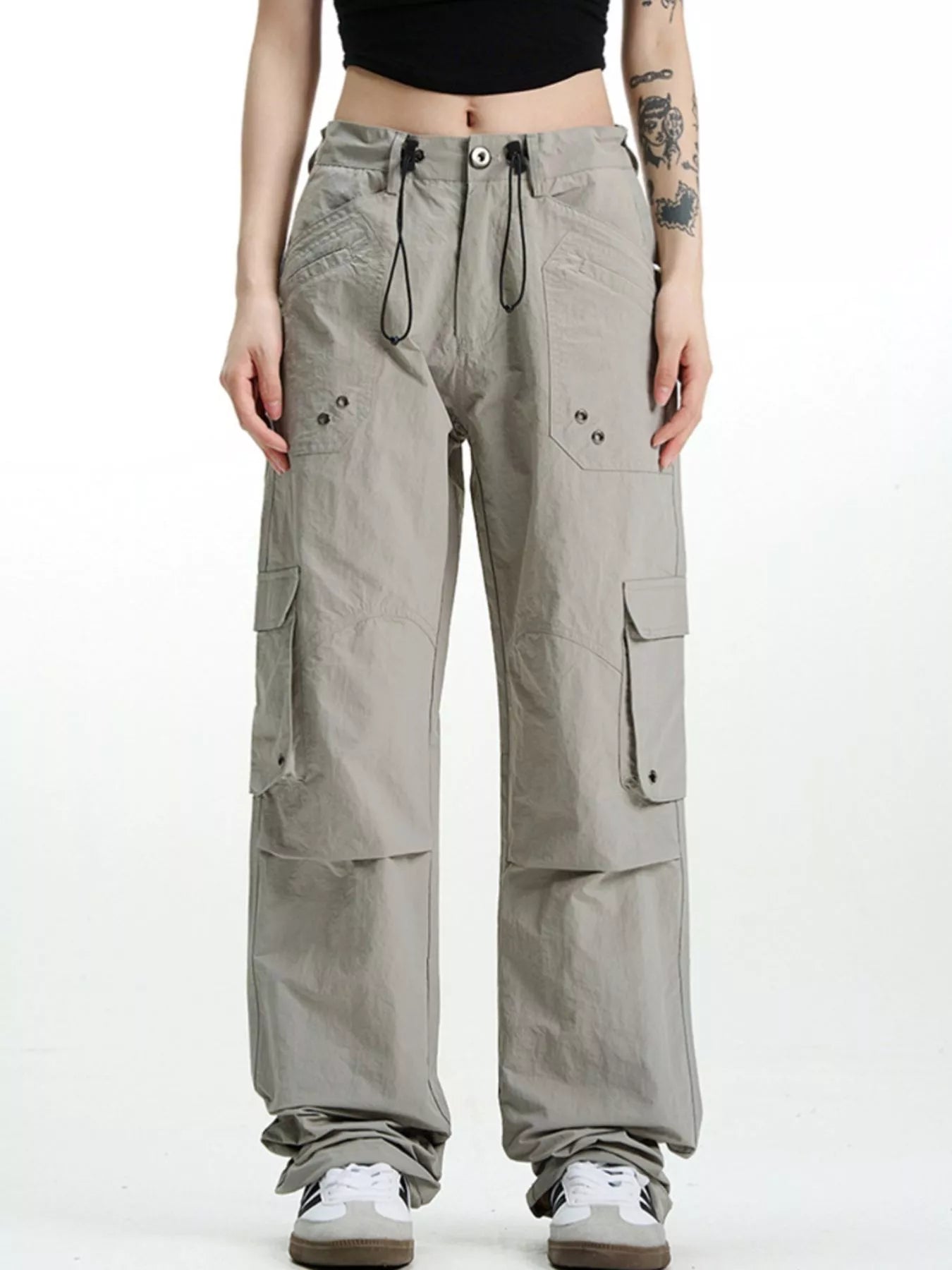 Relaxed fit grey cargo pants with multiple pockets and drawstring waist.