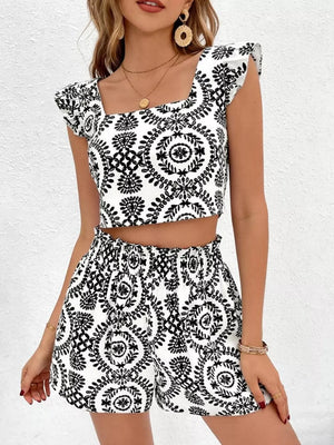 Chic black and white printed crop top with ruffle sleeves and matching high-waisted shorts.