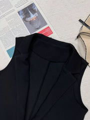 Black longline vest coat with notch collar and tailored seams.