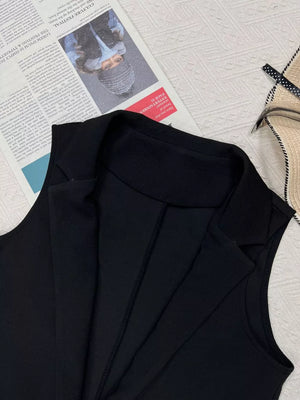 Black longline vest coat with notch collar and tailored seams.