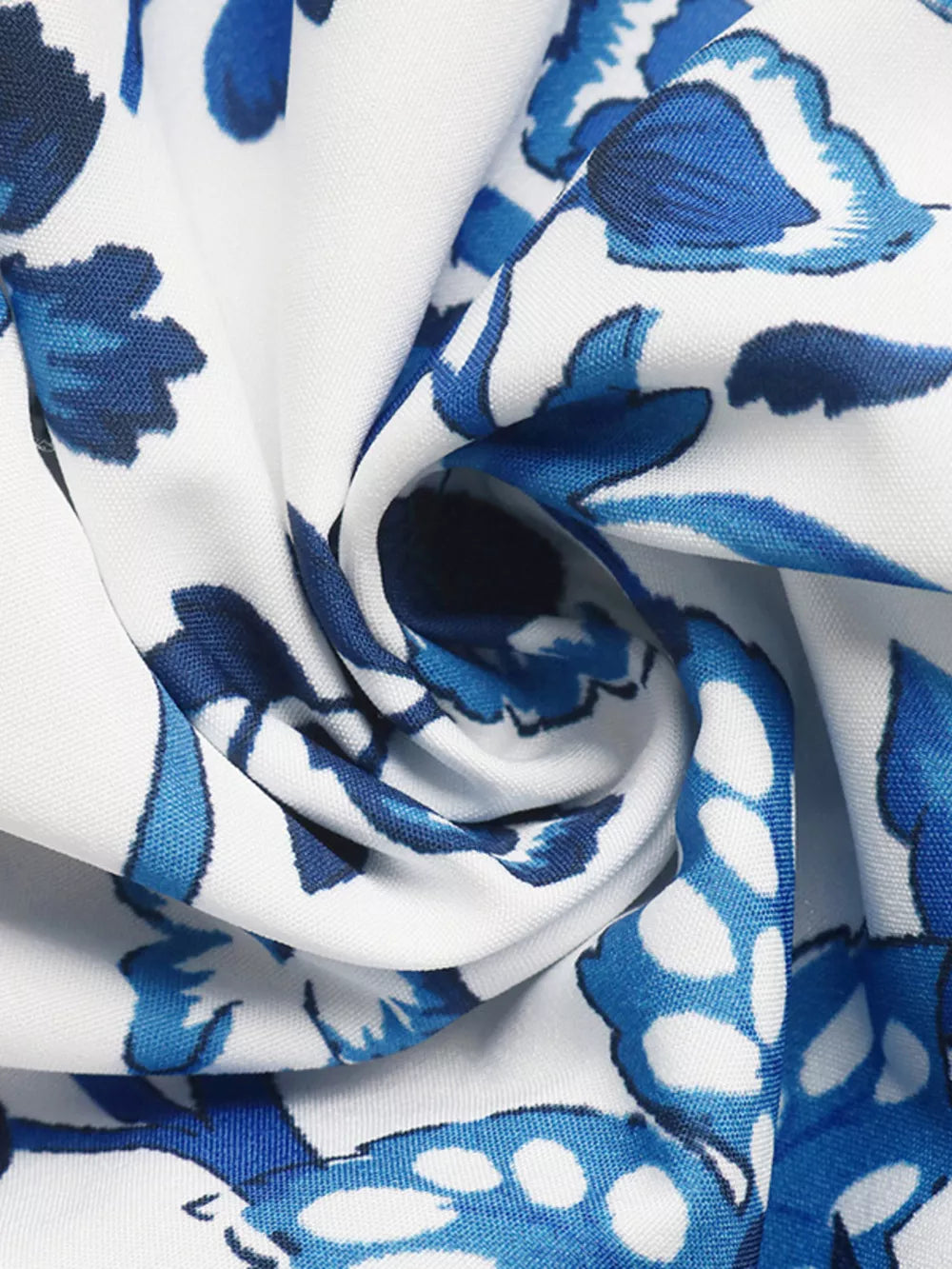 Floral halter neck cutout mini dress in white with blue floral print, fabric detail.
