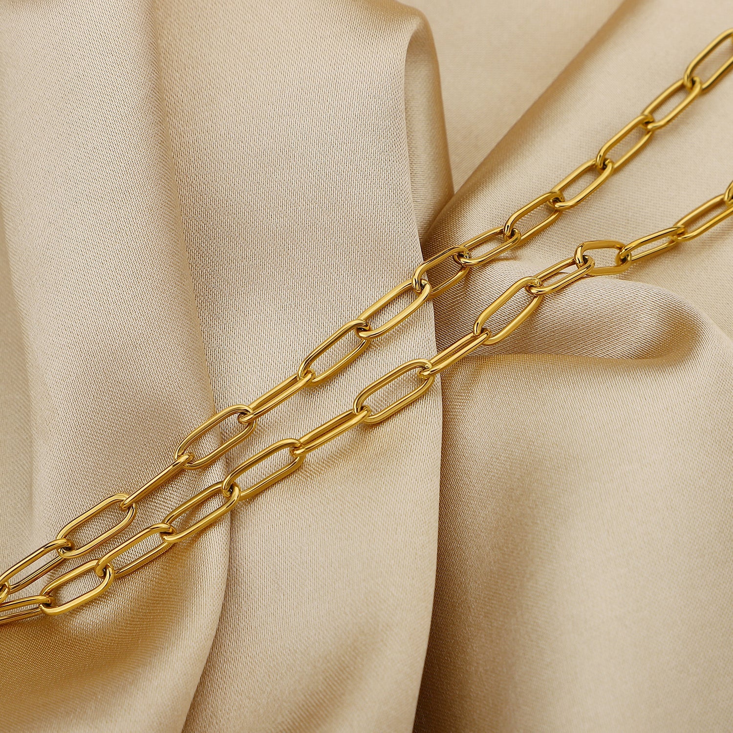 Gold-tone paperclip chain necklace with toggle clasp detail.
