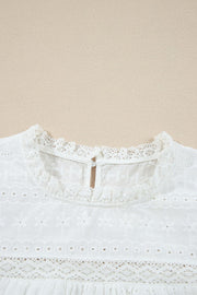 White eyelet yoke blouse with ruffle trim and lace details.