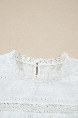 White eyelet yoke blouse with ruffle trim and lace details.