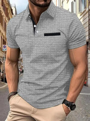Gray textured polo shirt with contrast black pocket detail and collar.