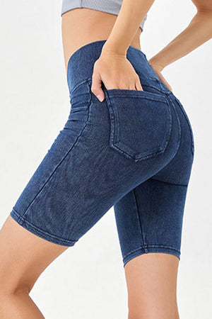 Denim bermuda shorts in dark blue with crisscross waistband detail and back pockets.