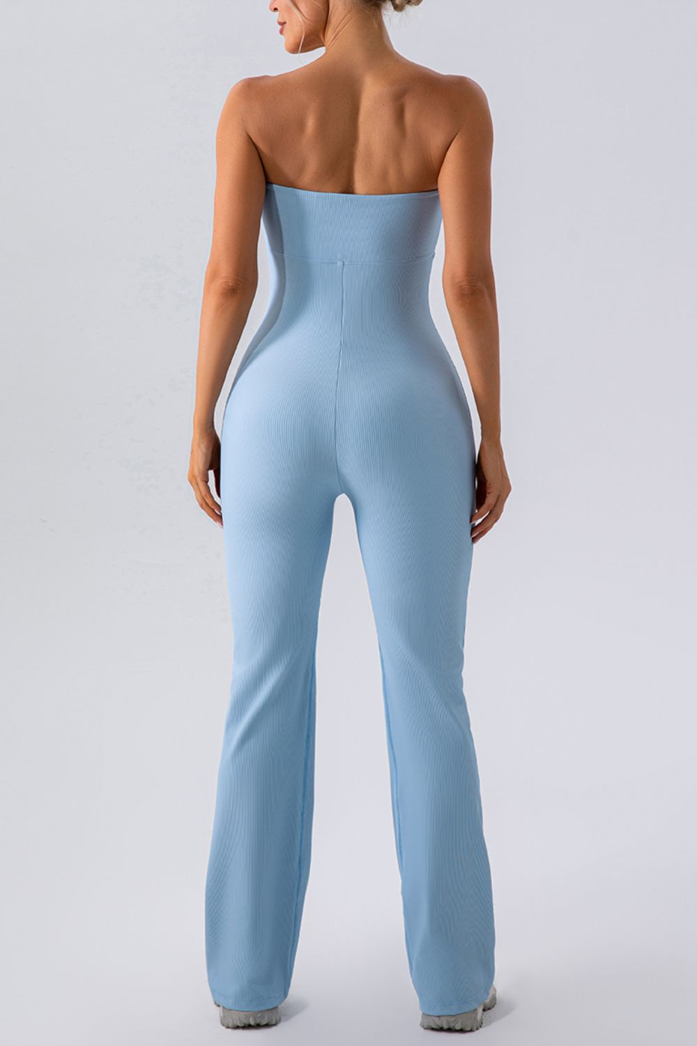 Light blue ribbed bandeau flare leg jumpsuit with a form-fitting silhouette.