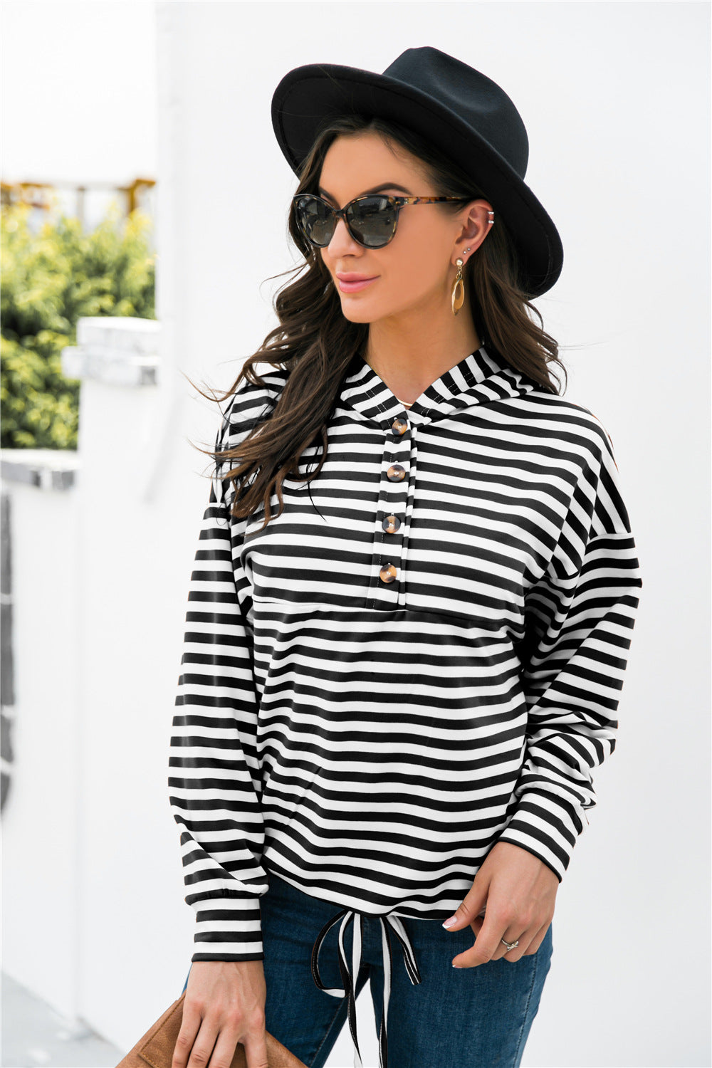 Black and white striped hoodie with button neck detail and drawstring waist.