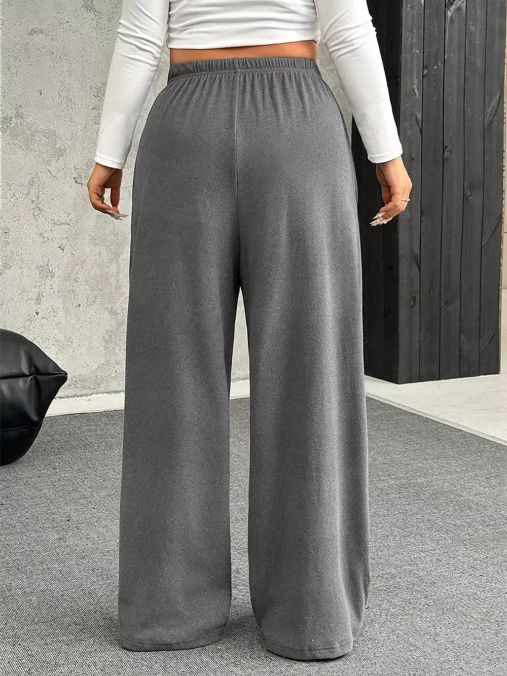 Maternity pants in gray with a drawstring waist and wide legs.