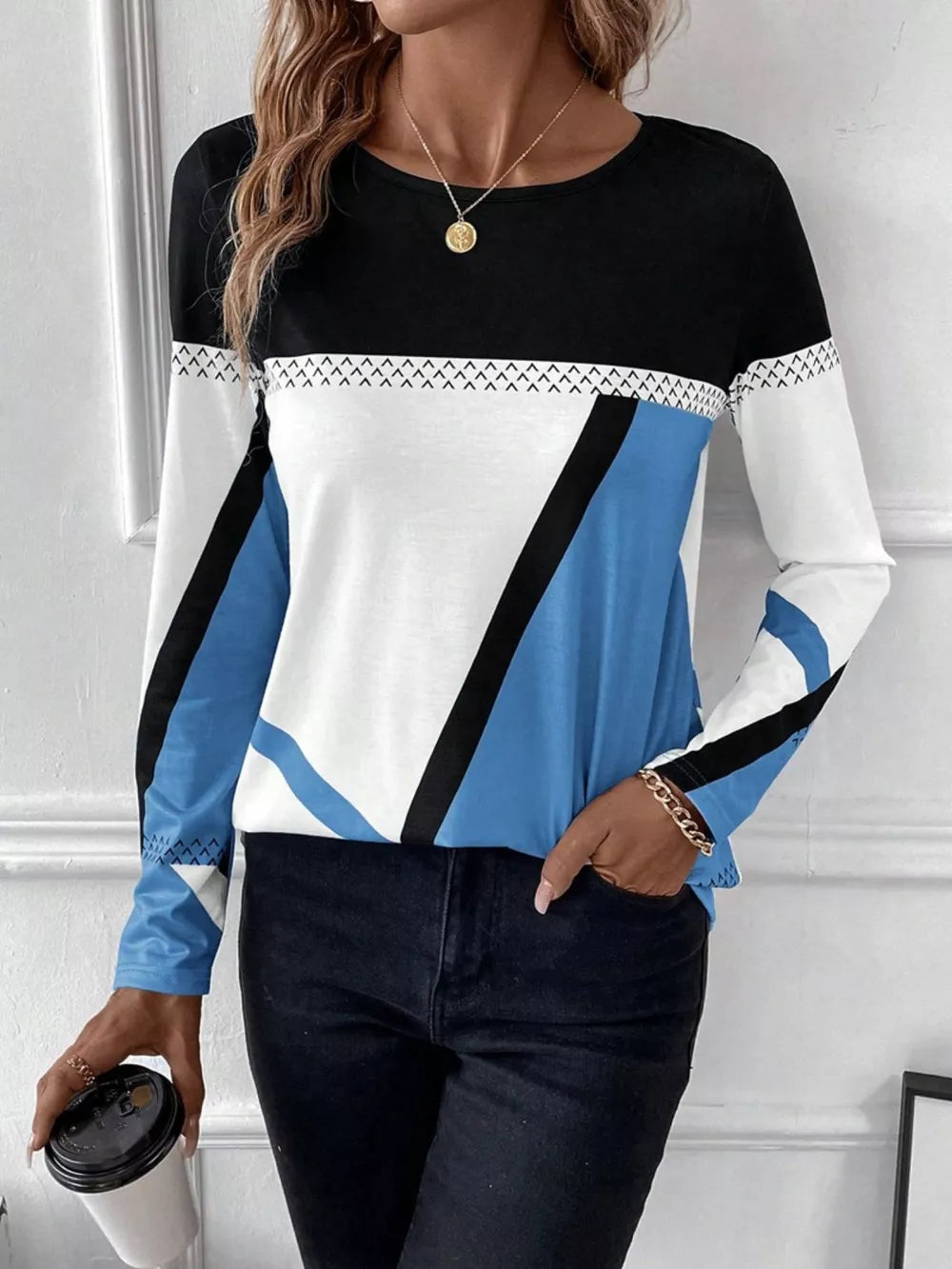 Geometric panel long sleeve t-shirt in black, white, and sky blue with chevron detail.